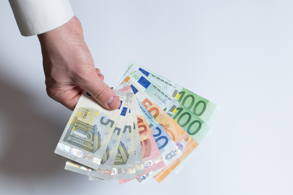 Money,In,Hands,On,A,White,Background.,Hand,Holding,Euro